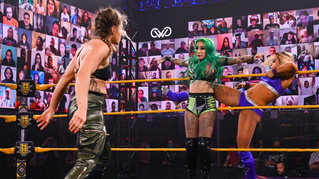 Zoey Stark kicks Shitzi Blackheart in the back as Marina Shafir advances