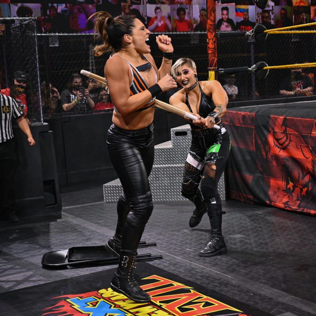 Rhea Ripley hits Raquel Gonzalez with a kendo stick