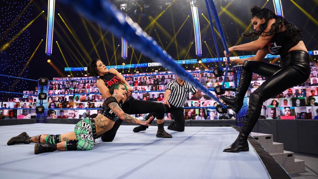 Billie Kay tries to push the rope closer to Ruby Riott to free herself from Bayley's submission