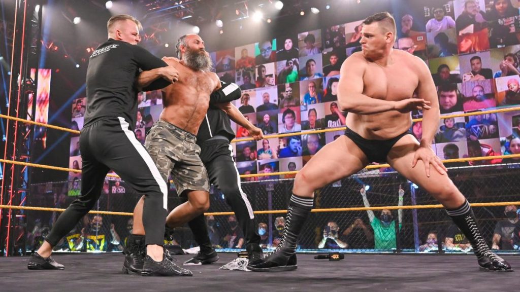 Barthel and Aichner hold Ciampa still for a chop from WALTER