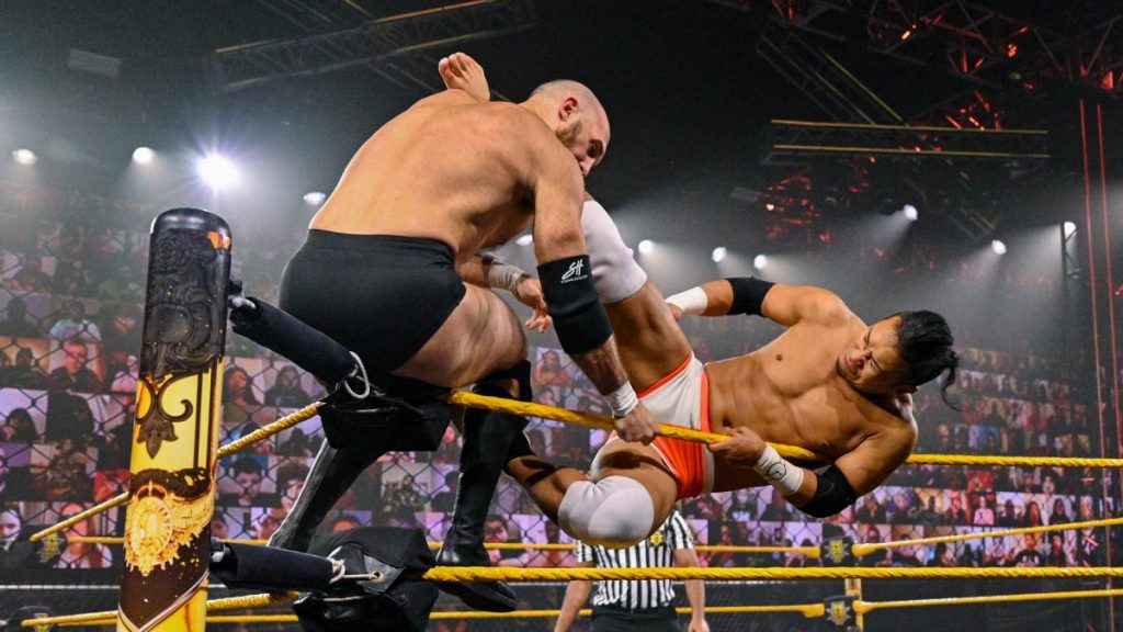 Kushida kicks Only Lorcan in the head while Lorcan is sat on the turnbuckle