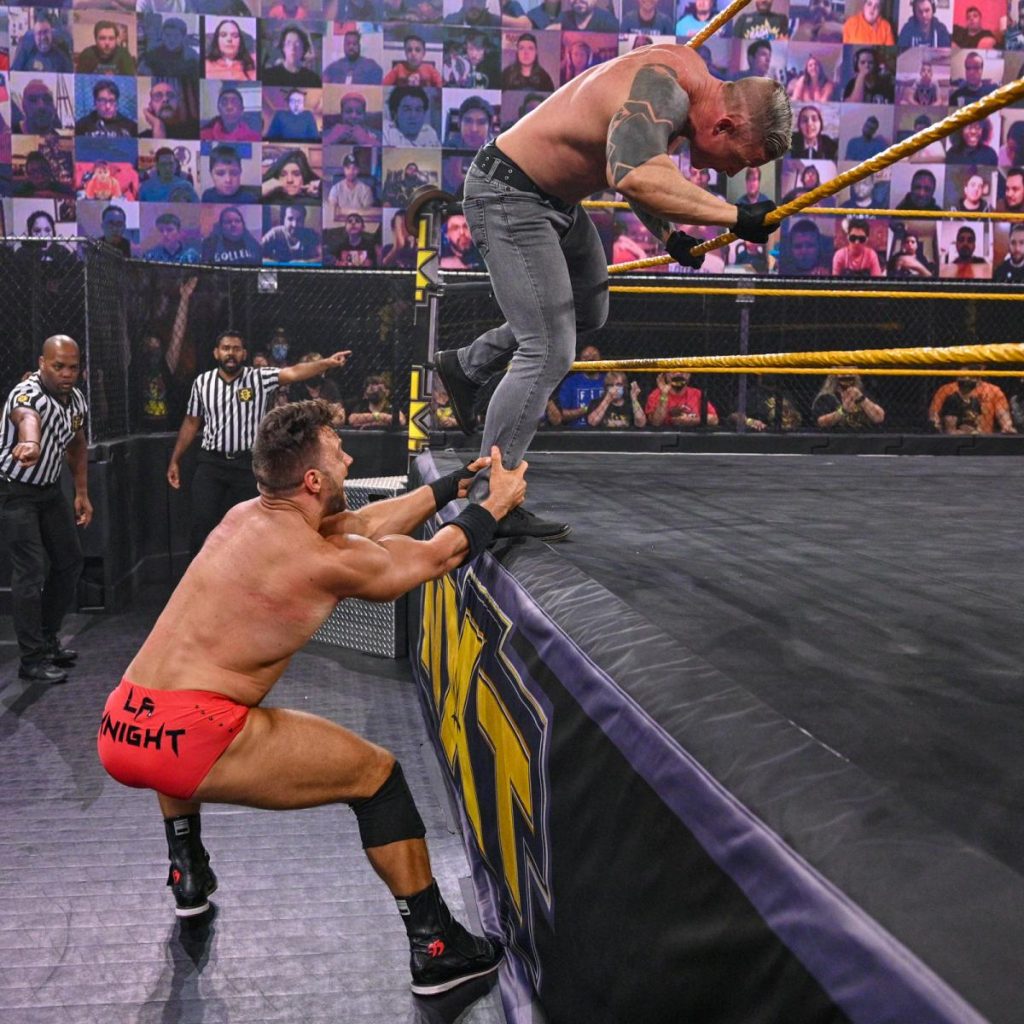 LA Knight pulls Dexter Lumis off the apron