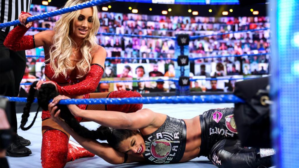 Carmella ties Belair's ponytail to the ropes