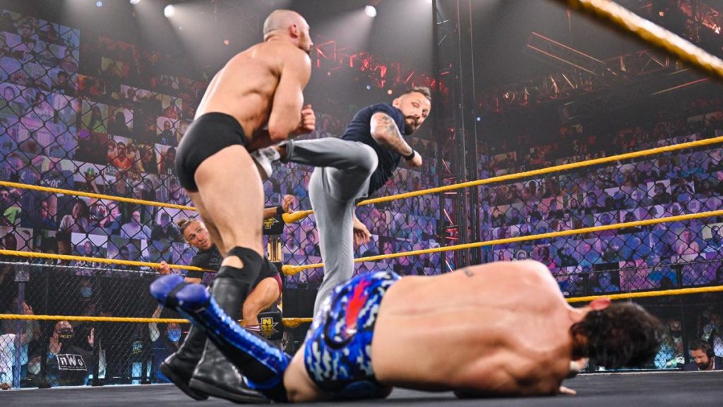 Bobby Fish kicks Oney Lorcan in the stomach with Kyle O''Reilly laying in the foreground.