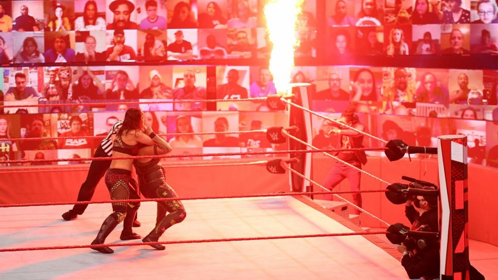 Fire shooting out of the ringpost scares Shayna Baszler and Tamina and knocks Reginald off the steps