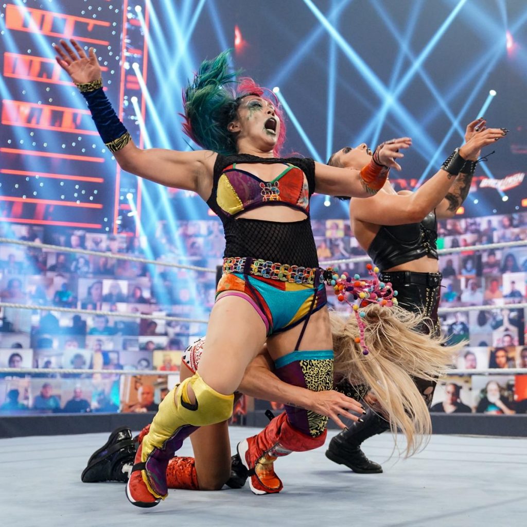 Charlotte Flair double chop blocks Asuka and Rhea Ripley