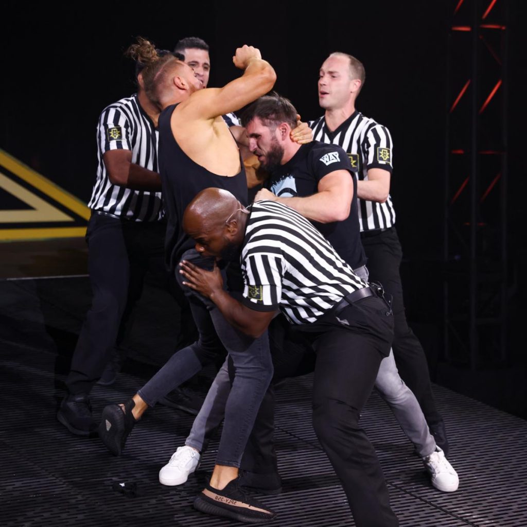 Officials try to separate Pete Dunne and Johnny Gargano