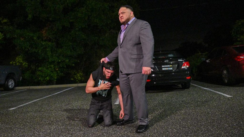 Samoa Joe holds Johnny Gargano by the shirt