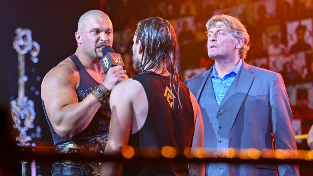 William Regal looks on as Karrion Kross and Adam Cole argue