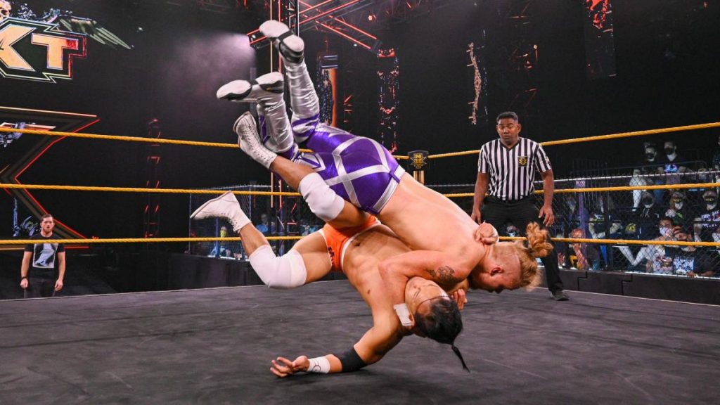 Kushida and Trey Baxter with Kyle O'Reilly in the background