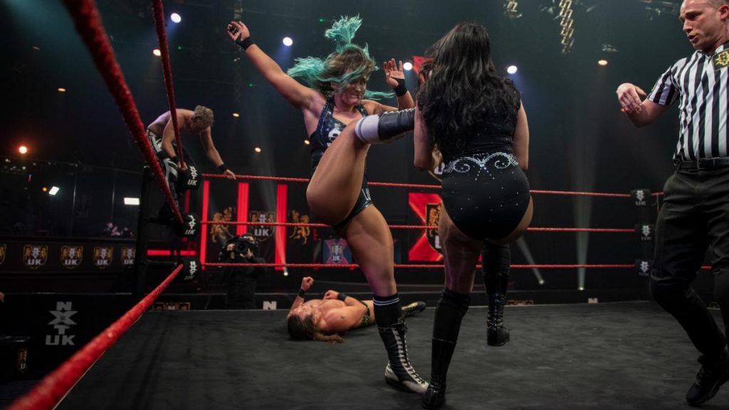 Dani Luna kicks Jinny with Flash Morgan Webster and Jospeh Connors in the background