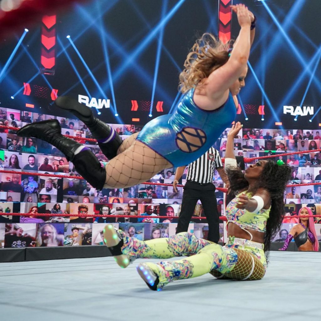 Piper Niven delivers a low crossbody to Naomi