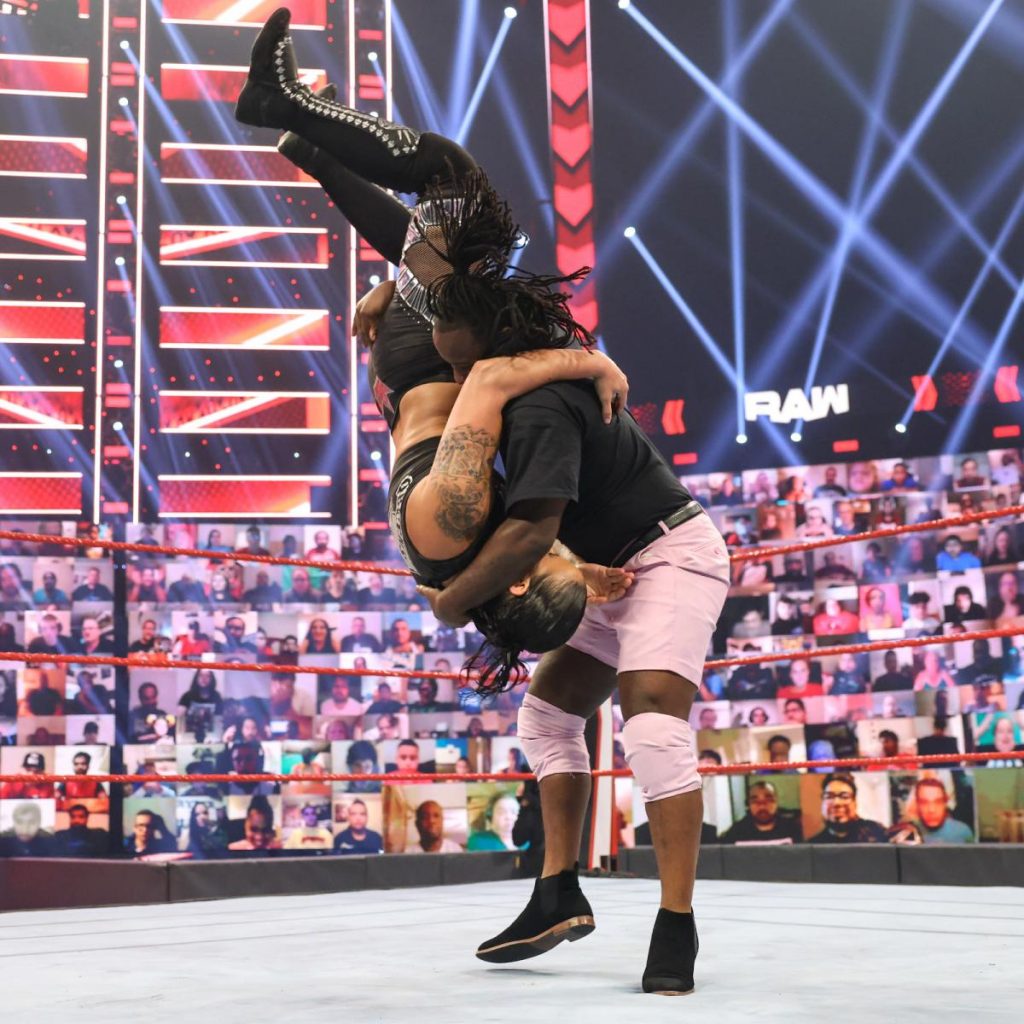Reginald bodyslams Shayna Baszler