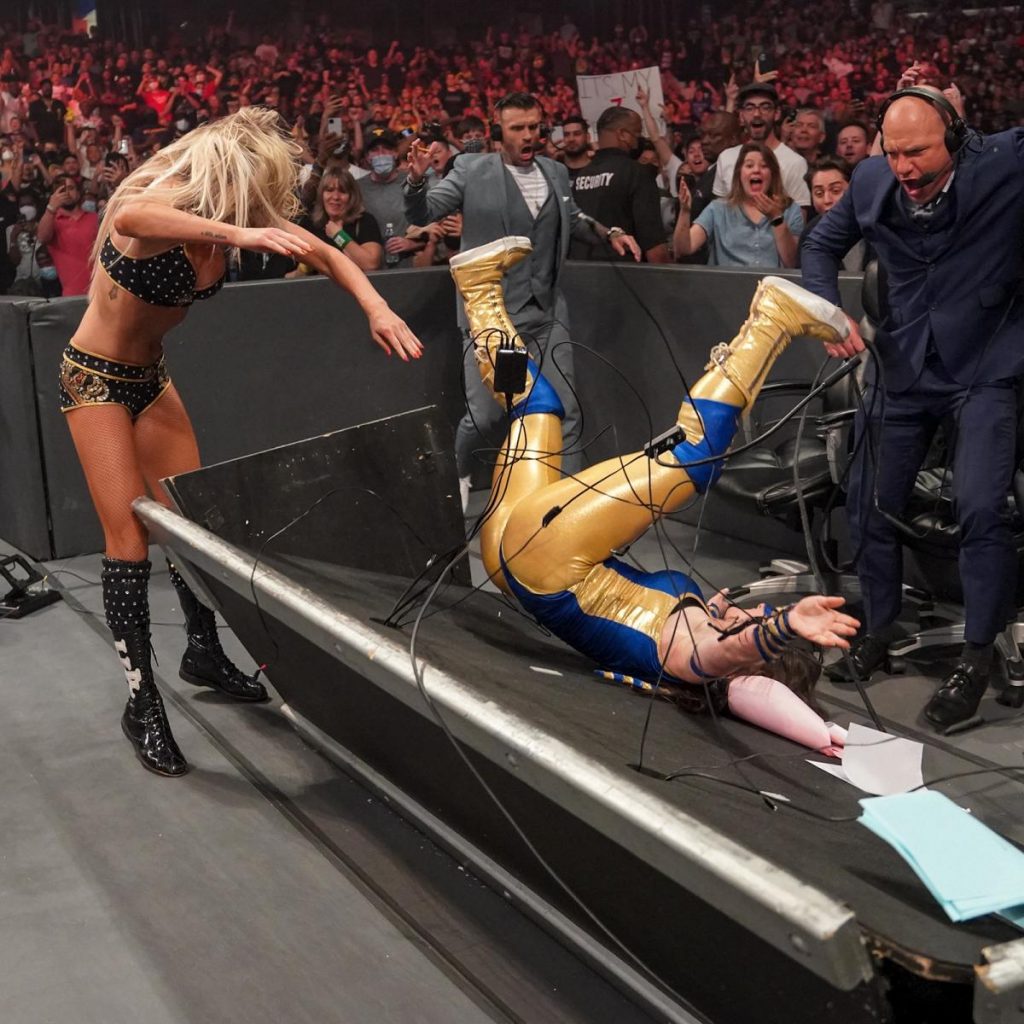 Charlotte Flair puts Nikki A.S.H. through the announce desk
