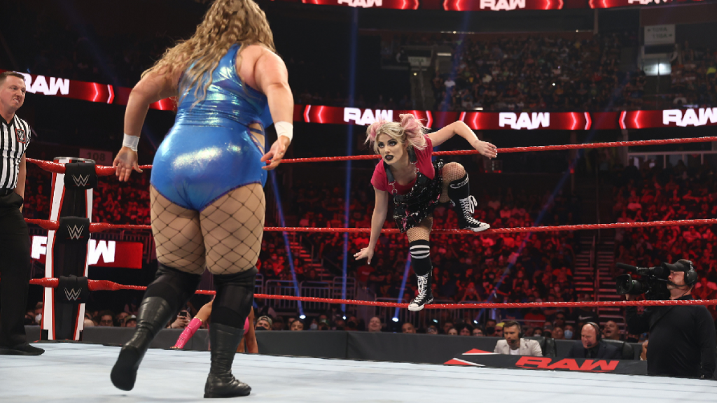 Doudrop stares at Alexa Bliss who's crouched in the ropes