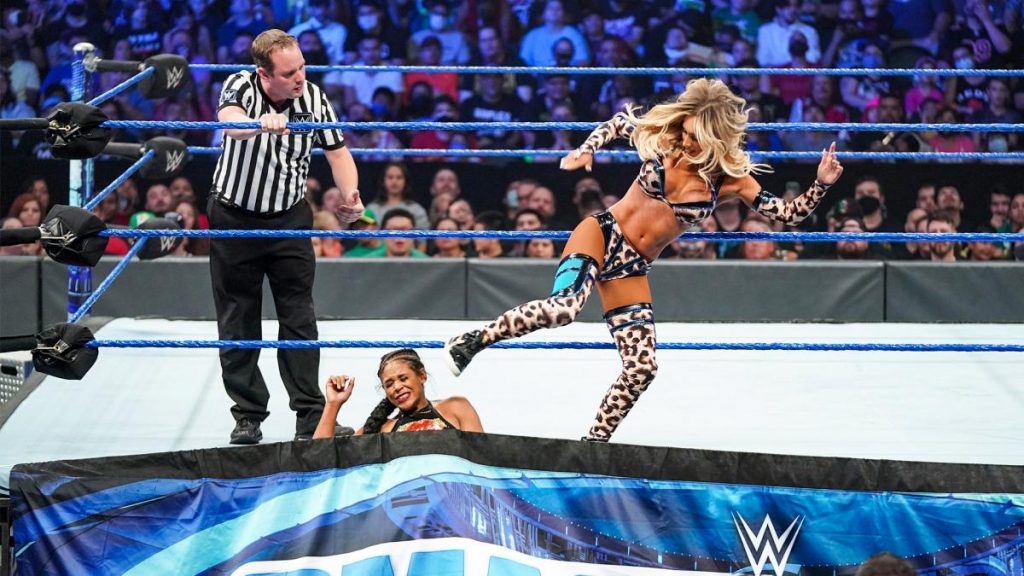 Carmella kicks Bianca Belair in the head while she has her trapped in the ring apron