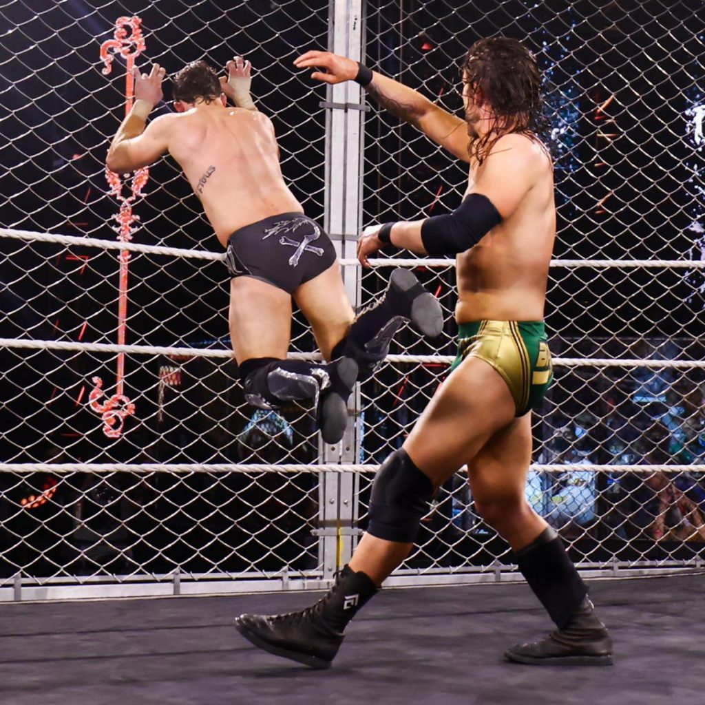 Adam Cole throws Kyle O'Reilly into the cage