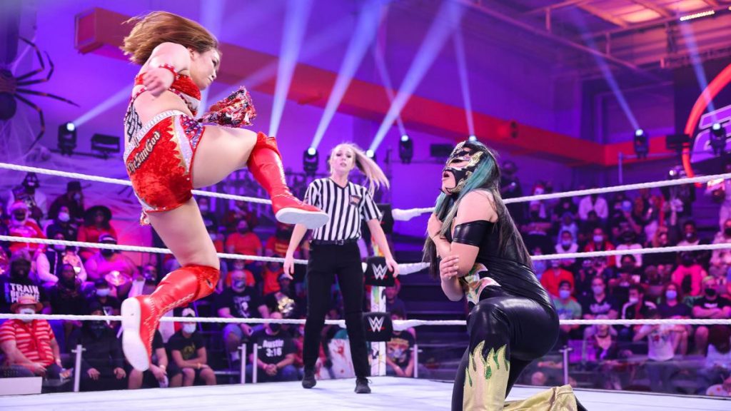 Sarray in mid flight to kick Katrina Cortez in the face