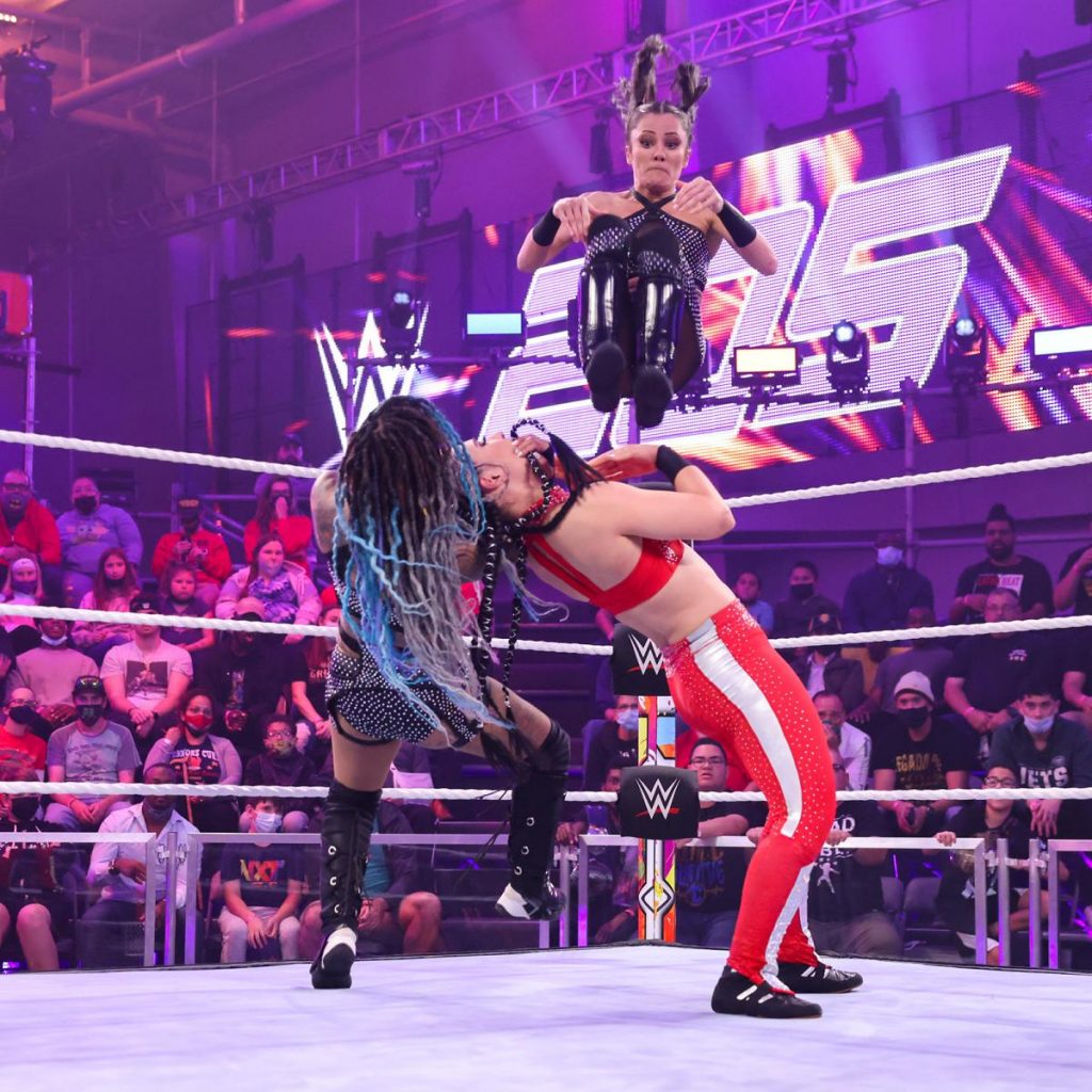Kacy Catanzaro and Kayden Carter deliver their double team finisher to Yulisa Leon