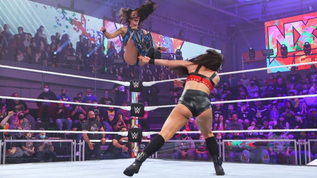 Cora Jade delivers a missile dropkick to Mandy Rose