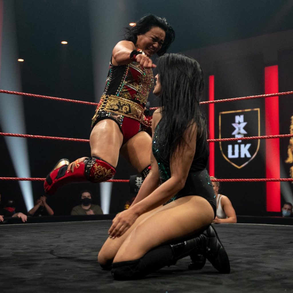 Meiko Satomura kicks Jinny in the chest.