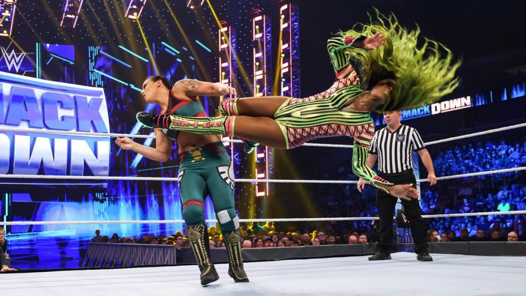 Naomi dropkicks Shayna Baszler