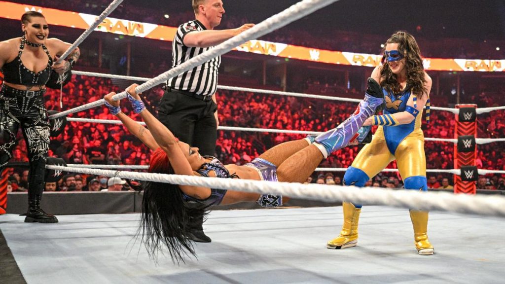 Nikki A.S.H. pulls Queen Zelina away from the ropes.