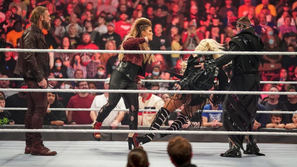 Beth Phoenix scares Maryse into falling over just by raising her fist.