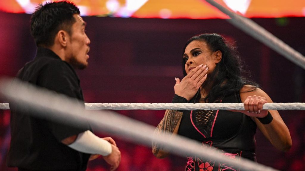 Tamina touches her face after Akira Tozawa's kick while Tozawa looks terrified