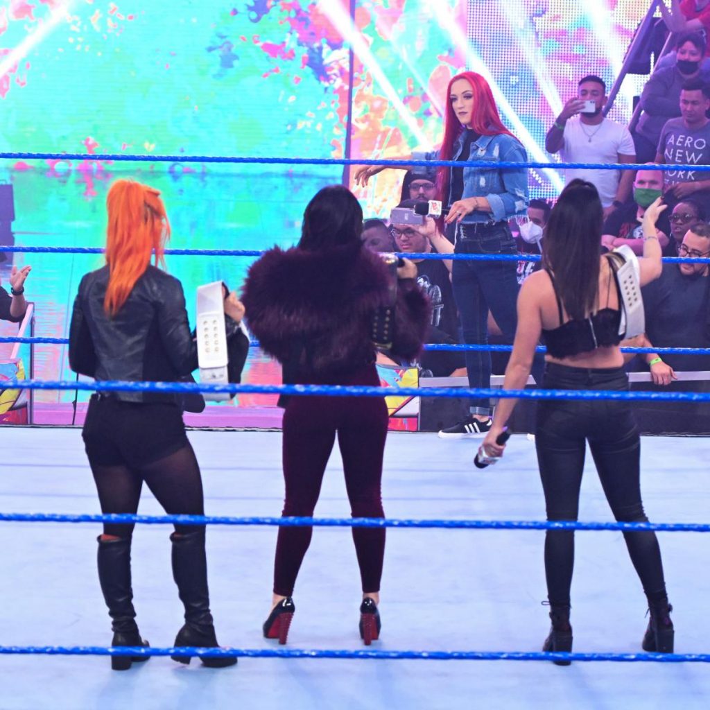 Kay Lee Ray, bat in hand, faces Toxic Attraction from the apron