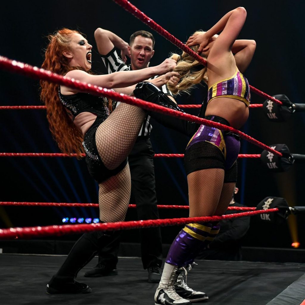 Isla Dawn uses Myla Grace's hair to pull her against the ropes