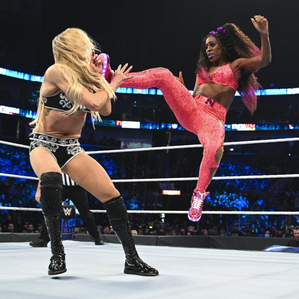 Naomi kicks Charlotte Flair in the head