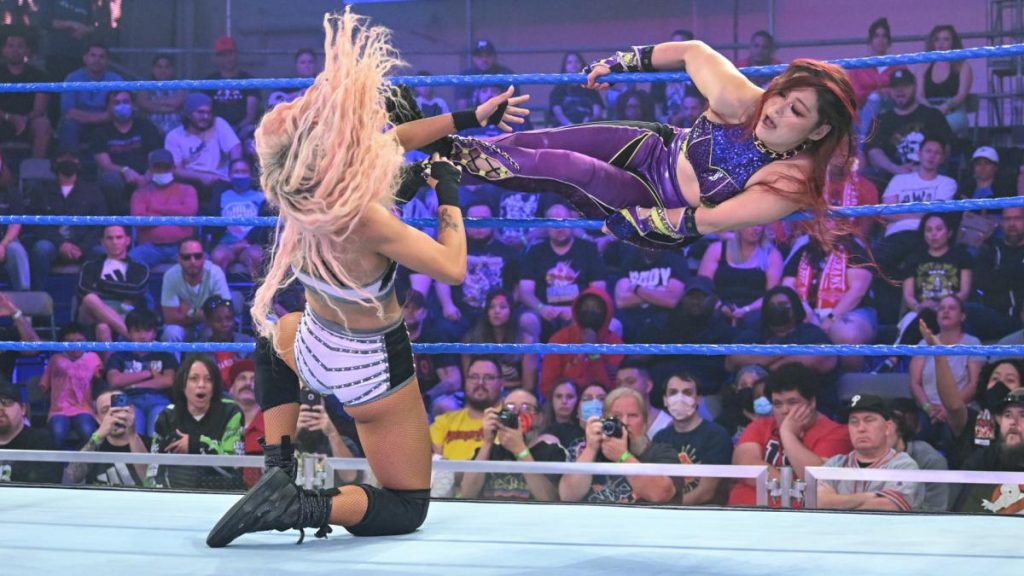 Io Shirai delivers the tiger feint kick to Dakota Kai