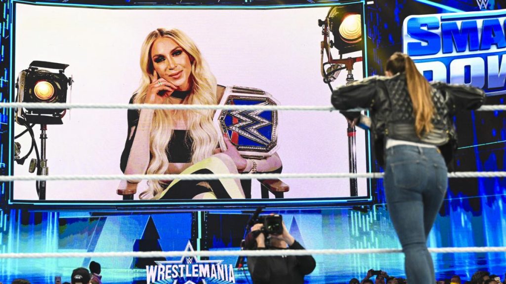 Ronda Rousey watches Charlotte Flair on the big screen
