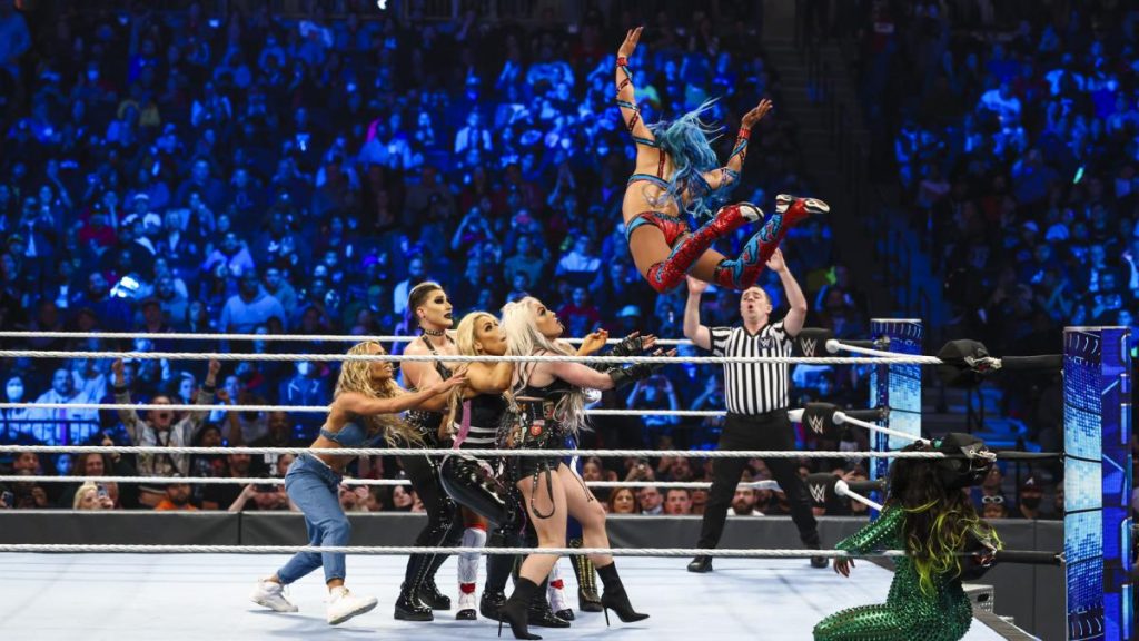 Sasha Banks flies onto Rhea Ripley, Liv Morgan, Carmella, and Queen Zelina while Naomi crouches in the corner